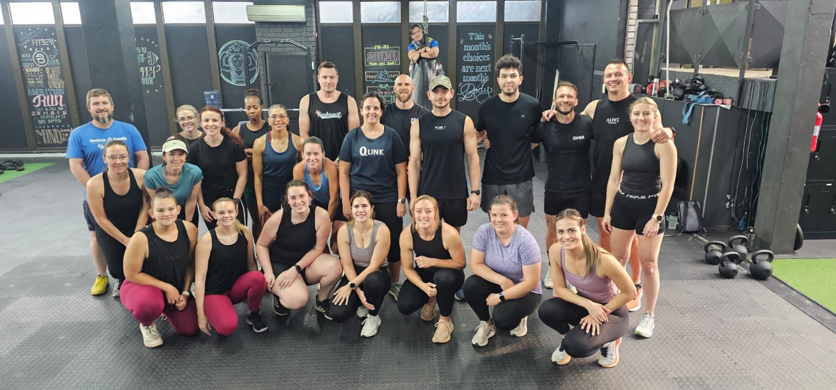 Group of Fitberi Members posing for a photo in the hybrid zone before a workout session