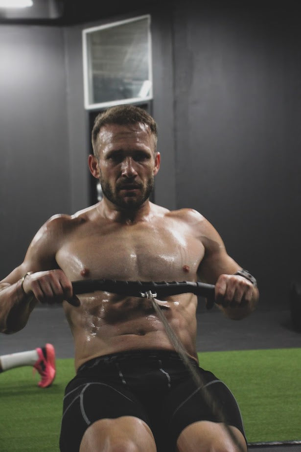 Man exercising on a rowing machine at the Fitberi Hybrid zone